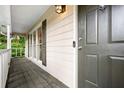 Inviting covered front porch featuring a dark-stained door and classic railing at 1131 Hershey Dr, Marietta, GA 30062