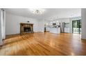 Bright living area with a cozy fireplace and gleaming hardwood floors, seamlessly connected to the kitchen at 1131 Hershey Dr, Marietta, GA 30062