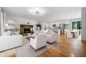 Spacious living room with a stone fireplace and hardwood floors, open to kitchen at 1131 Hershey Dr, Marietta, GA 30062