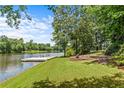 Lakeside backyard with a dock and seating area, perfect for relaxation at 55 Moray Pl, Covington, GA 30014