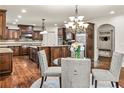 Spacious kitchen with dark wood cabinetry, stainless appliances, and a center island at 55 Moray Pl, Covington, GA 30014