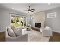 Cozy living room with a fireplace, plush seating, and sliding glass doors leading to the outdoor space at 6320 Halcyon Garden Dr, Alpharetta, GA 30005