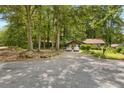 Charming single-story home nestled among mature trees with a spacious driveway at 652 Post Oak Rd, Jonesboro, GA 30238