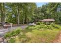 Quaint single-story home surrounded by lush greenery, offering a serene and private setting at 652 Post Oak Rd, Jonesboro, GA 30238