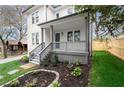 Inviting front porch featuring elegant railings, a stylish blue door, and meticulously maintained landscaping at 779-A Lynwood Se St, Atlanta, GA 30312