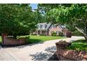 Manicured front yard and brick entrance leading to the charming brick home with a covered front porch at 1642 Reflections Trl, Powder Springs, GA 30127