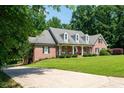Well maintained brick home features an extended driveway and lush green front yard at 1642 Reflections Trl, Powder Springs, GA 30127