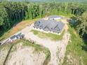Aerial view of charming one story home with a large roof, detached garage and horse trails at 1730 Etchison Spur, Loganville, GA 30052
