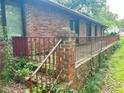 Brick home featuring a small porch with a rusted railing at 2641 Old Norcross Rd, Tucker, GA 30084