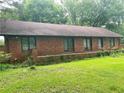 Side view of a brick home featuring a large yard and mature trees at 2641 Old Norcross Rd, Tucker, GA 30084