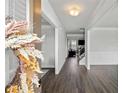 Inviting foyer with wood-look floors, wainscoting, and stylish decor welcoming you into this charming home at 3717 Blue Goose Ln, Loganville, GA 30052