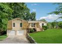Charming two-story home with a two-car garage, a welcoming front porch, and a beautifully landscaped front yard at 3753 Eli Dr, Snellville, GA 30039