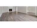 Spacious living room boasts a charming fireplace and stylish wood flooring, creating a cozy and inviting atmosphere at 3753 Eli Dr, Snellville, GA 30039