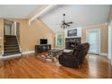 Living room with cathedral ceilings, hardwood floors, and stone fireplace, perfect for relaxing at 1105 Tom Lane Ln, Marietta, GA 30066