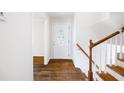 Bright foyer featuring hardwood floors and staircase, creating a warm welcome into the home at 255 Jade Cove Dr, Roswell, GA 30075