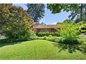 Well-maintained front yard with mature trees and lush green grass, perfect for outdoor enjoyment at 255 Jade Cove Dr, Roswell, GA 30075