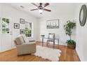 Bright office space with hardwood floors, a comfortable chair, and a large window for natural light at 528 Lantern Wood Dr, Scottdale, GA 30079