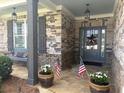 Charming front porch with stone accents and patriotic decor at 848 Rolling Nw Hl, Kennesaw, GA 30152