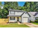 Charming two-story home featuring a well-manicured lawn, single car garage, and fresh landscaping at 131 Turning Point, Stockbridge, GA 30281