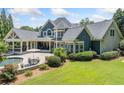 Spacious backyard offers a large patio, built-in pool, and a covered porch, perfect for outdoor gatherings at 3090 Creek Tree Lane, Cumming, GA 30041