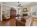 Cozy living room featuring a fireplace, comfortable seating, and hardwood floors at 11715 Dancliff Trce, Alpharetta, GA 30009