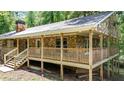 Ranch-style home with a covered wooden porch and stone exterior, with stairs leading up to the entrance at 257 Martin Ln, Canton, GA 30114