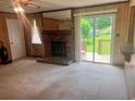 Cozy living room with a brick fireplace and sliding glass doors leading to the backyard at 4380 Highway 138, Oxford, GA 30054