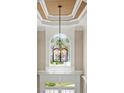 Elegant chandelier and foyer with a grand staircase at 2602 Alcovy Club Dr, Dacula, GA 30019