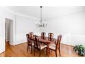 Formal dining room with hardwood floors, chandelier, and classic trim at 8073 Ridge Vly, Woodstock, GA 30189