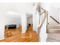 Inviting foyer with hardwood floors, staircase, and archway to living spaces at 8073 Ridge Vly, Woodstock, GA 30189