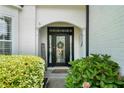 Elegant front door with decorative glass, complemented by lush greenery and a welcoming ambiance at 217 Springs Xing, Canton, GA 30114