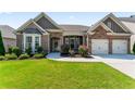 Charming single-story home with a brick facade, manicured lawn, and attached two-car garage at 2844 Bluestone Sw Dr, Atlanta, GA 30331