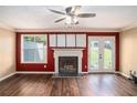 Cozy living room with a fireplace, wood floors, neutral walls, and natural light at 3835 Conley Downs Dr, Decatur, GA 30034