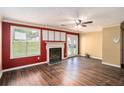 Cozy living room with a fireplace, wood floors, neutral walls, and natural light at 3835 Conley Downs Dr, Decatur, GA 30034