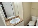 Functional bathroom featuring a standard toilet, vanity with sink, and chrome fixtures at 5595 Marbut Rd, Lithonia, GA 30058