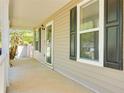 Relaxing covered porch featuring neutral siding and black shutter accents at 179 Glynn Addy Dr, Stockbridge, GA 30281