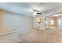 Open-concept living room features neutral walls, a ceiling fan, and seamless transition to the kitchen at 179 Glynn Addy Dr, Stockbridge, GA 30281