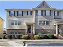 Charming two-story townhome with gray siding, brick accents, black shutters, and manicured landscaping at 3898 High Dove Sw Way # 12, Smyrna, GA 30082