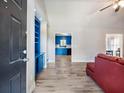 Inviting home entryway featuring hardwood floors, and a view into the kitchen at 443 Rhett Dr, Loganville, GA 30052