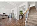 Bright living room with hardwood floors, staircase, and neutral decor with plenty of space to entertain at 865 Athena Bnd, Fairburn, GA 30213