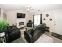 Bright living room showcasing a fireplace, vaulted ceiling, and stylish black leather seating at 2397 Planters Cove Dr, Lawrenceville, GA 30044