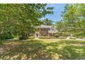 Traditional brick home with well-maintained landscaping and a lush green lawn at 4989 Woodfall Sw Dr, Lilburn, GA 30047