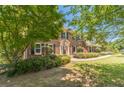 Beautiful brick home on a landscaped lot, featuring a well-maintained lawn at 4989 Woodfall Sw Dr, Lilburn, GA 30047