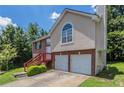 Two-story home with brick and stucco exterior, showing the front yard and side of the home at 999 Brecken Ln, Lithonia, GA 30058