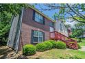 Two-story home with brick and stucco exterior, showing the front yard and side of the home at 999 Brecken Ln, Lithonia, GA 30058