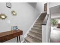 Inviting stairway with carpeted steps and contemporary decor leading to the upper level at 102 Oak Pl, Villa Rica, GA 30180