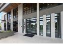 Commercial building entryway with black framed windows, glass doors and a cement exterior at 2285 Peachtree Ne Rd # 1202, Brookhaven, GA 30309