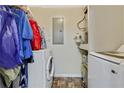 Utility room features washer, dryer and shelving for storage solutions at 12303 Waldrop Pl, Decatur, GA 30034