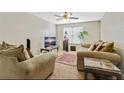 Inviting living room with plush seating, a ceiling fan and a large window for natural light at 12303 Waldrop Pl, Decatur, GA 30034
