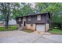 Two-story home featuring an attached garage, front lawn, and a driveway at 1966 Snapfinger Rd, Decatur, GA 30035